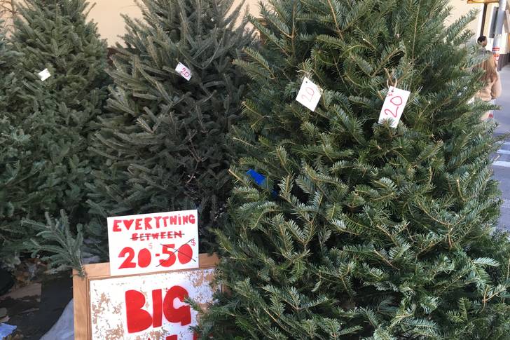 Christmas trees at deep discounts on Grand and Clinton Streets on Christmas Eve.